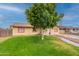 Attractive house featuring green lawn, mature trees, and side parking at 4160 W Granada Rd, Phoenix, AZ 85009
