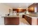 Spacious kitchen with island, wood cabinets, and granite countertops at 4160 W Granada Rd, Phoenix, AZ 85009