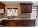 This kitchen features a double sink, granite counters, and cabinets under the window at 4160 W Granada Rd, Phoenix, AZ 85009