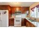 Functional kitchen featuring granite countertops, ample cabinetry, and a white refrigerator at 4160 W Granada Rd, Phoenix, AZ 85009