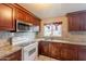 Kitchen featuring granite countertops, sink, and wood cabinets with stainless steel microwave at 4160 W Granada Rd, Phoenix, AZ 85009