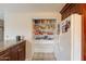 Kitchen pantry with shelving and a side view of a white refrigerator at 4160 W Granada Rd, Phoenix, AZ 85009