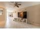 Comfortable living area with tile flooring, ceiling fan, and entertainment center at 4160 W Granada Rd, Phoenix, AZ 85009