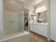 Spacious bathroom with double sinks, large mirror, and a glass shower at 4293 E Sourwood Dr, Gilbert, AZ 85298