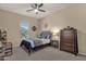 Comfortable bedroom with neutral walls, carpet flooring, a ceiling fan, a window, and lots of natural light at 4293 E Sourwood Dr, Gilbert, AZ 85298
