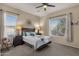 Inviting bedroom featuring neutral walls, carpet flooring, and a comfortable bed with lots of natural light and ceiling fan at 4293 E Sourwood Dr, Gilbert, AZ 85298