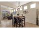 Well-lit dining area with table and chairs, decorative wall art, lots of natural light, and neutral paint at 4293 E Sourwood Dr, Gilbert, AZ 85298