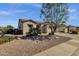 Charming single-story home with desert landscaping, a beautiful tree, and a two car garage at 4293 E Sourwood Dr, Gilbert, AZ 85298