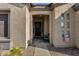 Inviting front porch with decorative wreath, a cozy sitting area, and desert-friendly landscaping at 4293 E Sourwood Dr, Gilbert, AZ 85298