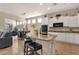 Open concept kitchen with granite countertops, island with breakfast bar, and stainless steel appliances, adjacent dining area at 4293 E Sourwood Dr, Gilbert, AZ 85298