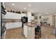 Modern kitchen featuring granite countertops, ample storage, and stainless steel appliances with view to living room at 4293 E Sourwood Dr, Gilbert, AZ 85298