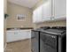 Modern laundry room with front-load washer and dryer, sink, and white cabinets at 4293 E Sourwood Dr, Gilbert, AZ 85298