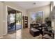Relaxing living area featuring tile flooring, a leather couch, sliding glass doors to a patio, and lots of natural light at 4293 E Sourwood Dr, Gilbert, AZ 85298