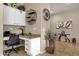 Cozy office nook with granite desk, built-in cabinets, adjacent to the kitchen, tile floors, and neutral paint at 4293 E Sourwood Dr, Gilbert, AZ 85298