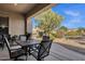 Relaxing covered patio with an outdoor dining set and views of the backyard at 4293 E Sourwood Dr, Gilbert, AZ 85298