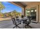 Covered patio featuring an outdoor dining set and views of the landscaped backyard at 4293 E Sourwood Dr, Gilbert, AZ 85298