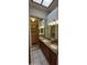 Bathroom featuring double sinks and a mirrored closet at 475 S Seawynds Blvd, Gilbert, AZ 85233