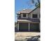 Exterior of a two-story home featuring a tile roof and a two-car garage with dark green doors at 475 S Seawynds Blvd, Gilbert, AZ 85233