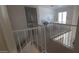 Upstairs hallway with white railing overlooking a lower room, leading to a bright room with a desk at 475 S Seawynds Blvd, Gilbert, AZ 85233