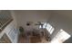 A bright living room with two cozy chairs, a ceiling fan, and large windows with shutters for natural light at 475 S Seawynds Blvd, Gilbert, AZ 85233