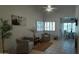 Comfortable living room featuring tile floors, neutral paint, shuttered windows, and tasteful decor at 475 S Seawynds Blvd, Gilbert, AZ 85233