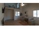 Spacious living room with tile floors, neutral paint, shuttered windows, and balcony view above at 475 S Seawynds Blvd, Gilbert, AZ 85233