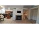 Open living area with fireplace, tile floors, view of staircase, and access to kitchen and dining area at 475 S Seawynds Blvd, Gilbert, AZ 85233