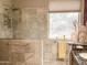Modern bathroom with tiled walk-in shower, sleek fixtures, and a window offering natural light at 4970 S Desert Willow Dr, Gold Canyon, AZ 85118