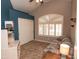 Bright bedroom with tile floor, a large window with shutters, and a closet with sliding doors at 4970 S Desert Willow Dr, Gold Canyon, AZ 85118