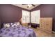 Comfortable bedroom featuring plantation shutters, tiled floors and soothing purple walls at 4970 S Desert Willow Dr, Gold Canyon, AZ 85118
