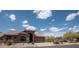Charming single-story home featuring desert landscaping and a tile roof under a bright blue sky at 4970 S Desert Willow Dr, Gold Canyon, AZ 85118