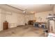 Spacious garage with ample storage space, a workbench, and a roll-up door with opener at 4970 S Desert Willow Dr, Gold Canyon, AZ 85118