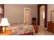 Cozy main bedroom with en-suite bathroom, featuring a large bed, tiled floors, and a view to the bathroom at 4970 S Desert Willow Dr, Gold Canyon, AZ 85118