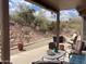 Covered back patio with comfortable seating, a table, and tranquil desert views at 4970 S Desert Willow Dr, Gold Canyon, AZ 85118