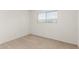 Bright bedroom featuring neutral carpet and a window with blinds allowing natural light at 520 N Stapley Dr # 253, Mesa, AZ 85203