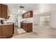 Kitchen features white appliances, wood cabinets, vinyl floor, and a view of the sliding patio door at 520 N Stapley Dr # 253, Mesa, AZ 85203