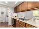 This kitchen features wood cabinets, stainless steel sink, and in-unit laundry at 520 N Stapley Dr # 253, Mesa, AZ 85203