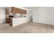 Kitchen and living area features wood cabinets, laminate countertops, and neutral walls at 520 N Stapley Dr # 253, Mesa, AZ 85203