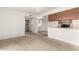 Bright living area features neutral carpet and seamless integration with the kitchen and dining area at 520 N Stapley Dr # 253, Mesa, AZ 85203