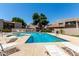 Community pool featuring lounge chairs and a hot tub surrounded by lush landscaping at 520 N Stapley Dr # 253, Mesa, AZ 85203