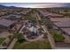 Aerial view of a community park featuring a playground and landscaped areas, surrounded by residential houses at 5239 W Leodra Ln, Laveen, AZ 85339