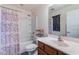 Bathroom featuring a combination shower and tub with a white surround and a vanity with framed mirror at 5239 W Leodra Ln, Laveen, AZ 85339