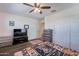 This cozy bedroom features a ceiling fan, gray wood-look floors, closet and plenty of storage space at 5239 W Leodra Ln, Laveen, AZ 85339