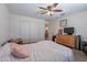 Bright bedroom with a closet and dresser for storage, plus a fan and wood-look flooring at 5239 W Leodra Ln, Laveen, AZ 85339
