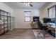 Office space with dual monitors, ceiling fan, hardwood floors, and a rolling office chair at 5239 W Leodra Ln, Laveen, AZ 85339