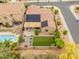 Aerial view of a backyard with solar panels, pool, and relaxing patio seating at 5649 E Desert Forest Trl, Cave Creek, AZ 85331