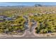 Scenic aerial view of a desert community featuring winding roads and mountain vistas at 5649 E Desert Forest Trl, Cave Creek, AZ 85331