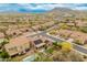 Aerial view of a desert neighborhood with tile roofs, lush desert landscaping, and mountain views at 5649 E Desert Forest Trl, Cave Creek, AZ 85331