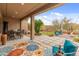 Inviting back patio with decorative rug, stylish outdoor furniture, and a well-maintained landscape at 5649 E Desert Forest Trl, Cave Creek, AZ 85331
