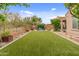 Expansive backyard featuring green turf, desert plants, and comfortable outdoor seating at 5649 E Desert Forest Trl, Cave Creek, AZ 85331